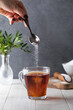 In a cup of tea, pour a sugar substitute from a teaspoon. Stevia, erythritol.