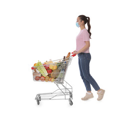 Poster - Woman with protective mask and shopping cart full of groceries on white background