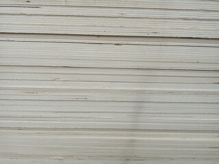 A stack of plywood sheets for construction. A pile of wooden chipboard sheets. Osb plywood.