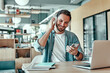 © Afshar Tetyana - Happy businessman listening music in headphones at cafe.
