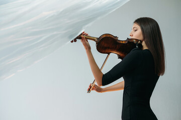 Wall Mural - Musician woman. Online concert. Lockdown reality. Hobby profession. Creativity freedom. Inspired lady playing violin with transparent plastic film under head isolated neutral copy space.