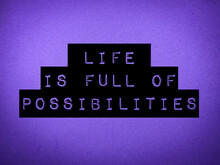 Selective Focus.Word Motivational Poster With Purple Background "Life Is Full Of Possibilities".