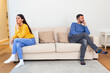 © Graphicroyalty - Husband and wife sitting on the couch and not talking after an argument at home. Social Distancing concept