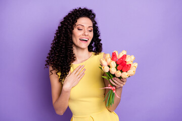 Poster - Photo of pretty young girl arm on chest hold flowers fascinated have good mood isolated on violet color background