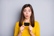 © deagreez - Portrait of attractive amazed funky girl holding in hands bank card pout lips novelty solution isolated over grey color background