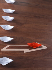 Wall Mural - New ideas, creativity and various innovative solutions or leadership concept, paper boats on an office table