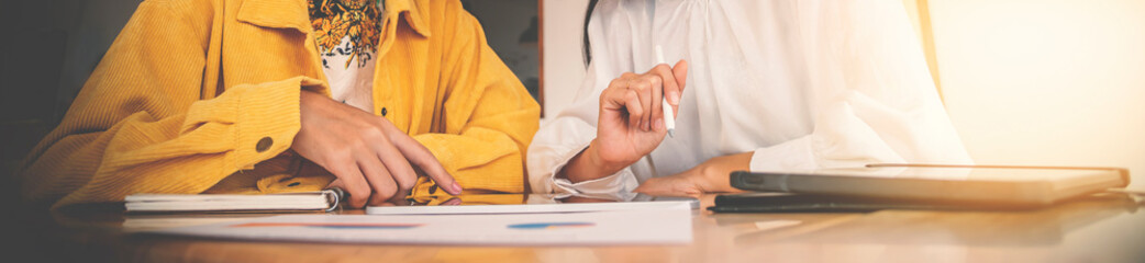 two businesswoman looking on tablet and talk about business, cover banner design.