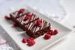 rich dark cocolate brownie cake desert with freeze dried raspsberries 