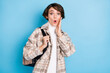 © deagreez - Photo of impressed cool lady stand with bag hand face wear shirt isolated on teal color background