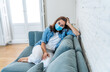 © SB Arts Media - Lonely woman suffering from depression at home during coronavirus lockdown and social distancing