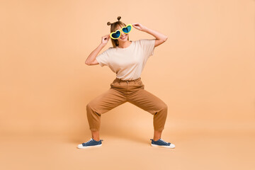 Canvas Print - Full body photo of young excited girl happy positive smile have fun hands touch sunglass isolated over beige color background