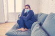 © SB Arts Media - Lonely woman suffering from depression at home during coronavirus lockdown and social distancing