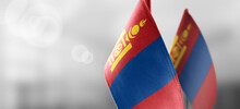 Small National Flags Of The Mongolia On A Light Blurry Background