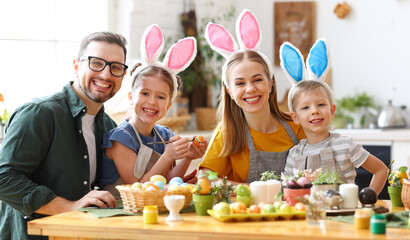 Wall Mural - happy family painting easter eggs in light kitchen