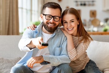 Wall Mural - Happy couple watching TV together