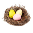 © Liza - Colorful three eggs in wooden bird nest isolated on the white background