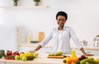 © Prostock-studio - Happy African Woman Posing In Kitchen Cooking Healthy Vegetable Dish