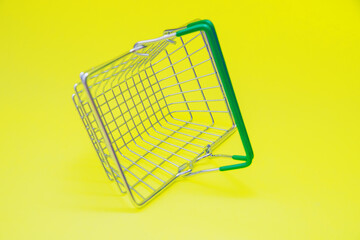 Small grocery metal supermarket shopping basket.Retail consumer purchases online. Delivery of goods to your home.