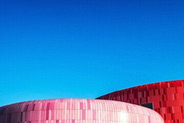 unusual round building with blue tiles example of modern architecture, with plenty of space and blue