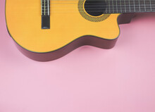  Flat Lay Of Acoustic Guitar On Pink Background With Copy Space.