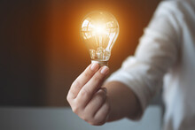 Ideas Creativity Concept, Woman Holding Light Bulb In Office..