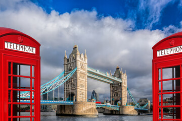 Wall Mural - London symbols with Tower bridge against red phone boots in England, UK