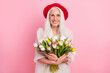© deagreez - Portrait of attractive cheerful grey-haired granny holding in hands tulips romance floristry isolated over pink pastel color background