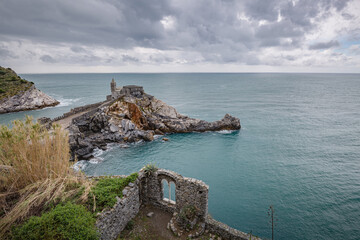 Portovenere (Porto Venere) in Liguria, Italy: beautiful aerial scenic view of the Church of St. Peter (Chiesa di San Pietro) from Doria castle nearby Cinque Terre