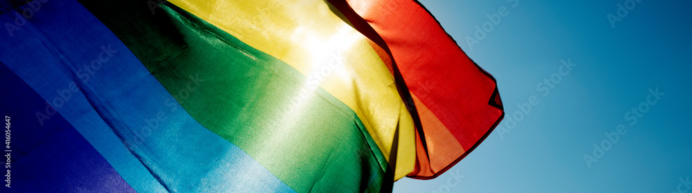 rainbow flag waving on the sky, web banner - obrazy, fototapety, plakaty 
