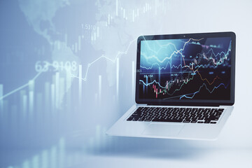 Online forex chart analysis with opened laptop with financial diagrams and lines on display at abstract stock market background. Double exposure