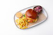 Photo of tasty delicious burger with fry potatoes and sauce over white background, fast food.