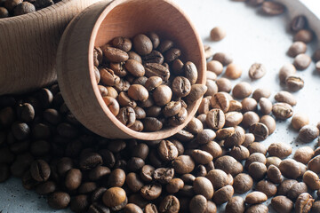 Brown roasted coffee beans falling on pile. Represent breakfast, energy, freshness or great aroma,Flying on dark background with copy space, close-up