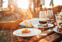 Wooden Table With Glassware Arranged For Picnic