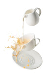 Fototapeta Na ścianę - pouring milk and splashing milk tea from flying cup and saucer isolated on white background