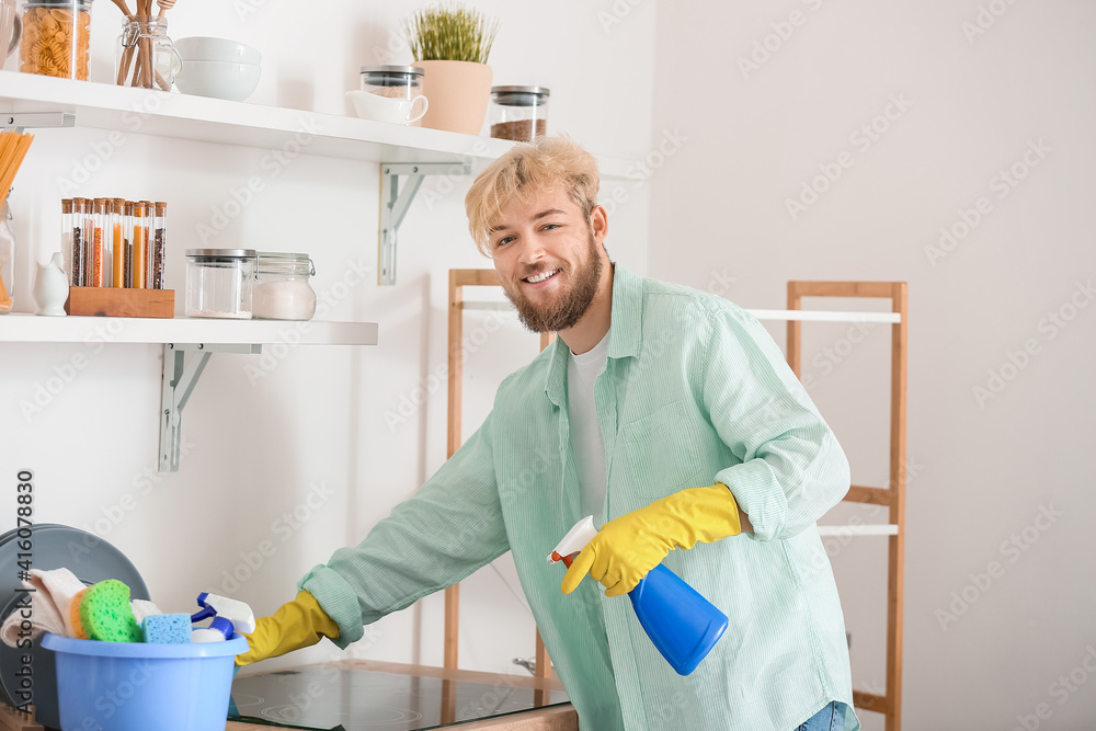 Young man cleaning his kitchen