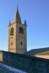 Wall Mural - Top of a medieval bell tower in the ancient village of Serralunga d'Alba against clear blue sky, Cuneo, Piedmont, Italy