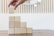 © Kantamard - Arrange the wooden blocks into steps, higher the marketing strategy the more effort is required, Ladder of success, Driving business at the peak concept.