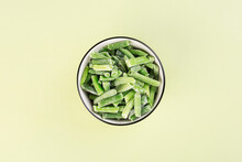 Frozen String Beans In A Bowl On A Green Background, Top View, Healthy Food