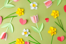 Pink Origami Tulips And Yellow Origami Narcissus On Green Pastel Background. Top View. Paper Cut Art. Springtime Seasonal Background. Hallo Spring Concept, Banner, Flyer, Invitation, Cute Card