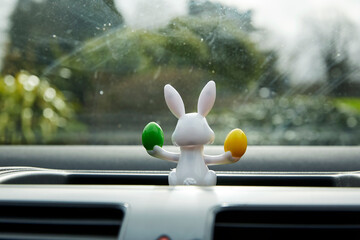 easter bunny with easter eggs solar powered toy in car window interior