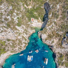 Wall Mural - Aerial view of tourists sunbath swim at Stiniva cove beach of Adriatic sea on Vis Island in Croatia summer