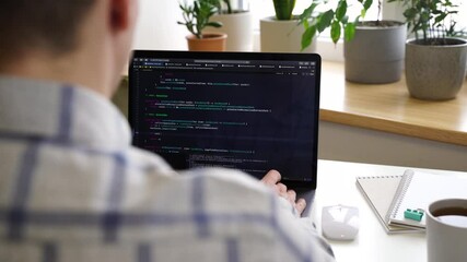 Wall Mural - code on the laptop screen, working environment in the office of programmers