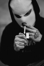 Gangster Lighting Up A Cigarette