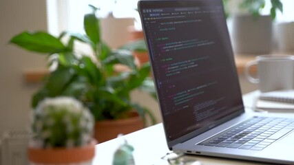 Wall Mural - code on the laptop screen, working environment in the office of programmers