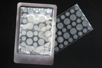 round patches for acne and wrinkles on a black background. acne and wrinkle patches for facial rejuv
