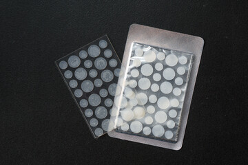round patches for acne and wrinkles on a black background. acne and wrinkle patches for facial rejuv