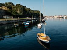 Small Boats In Weymouth's Harbor In A Sunny Morning. Yellow Boat.