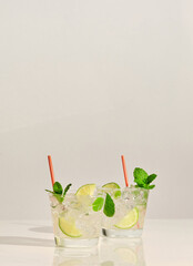 Wall Mural - A pair glasses of Mojito cocktail on white marble table. With copy space for your text.