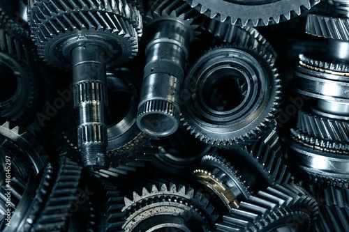 Closeup disassembled car automatic transmission gear part on workbench at garage or repair factory station for fix service or maintenance. Vehicle part detail. Complex industrial mechanism background