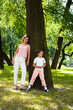 © iordani - young pretty mother walking with little cute daughter outside in green park, lifestyle poeple concept